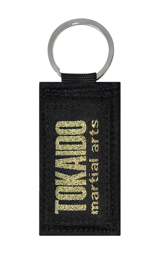 Karate Schlüsselanhänger, TOKAIDO martial arts Obi, schwarz-gold